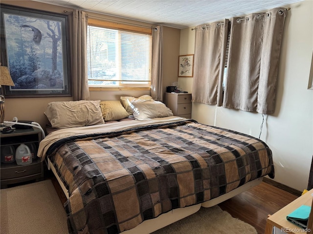 bedroom with hardwood / wood-style flooring