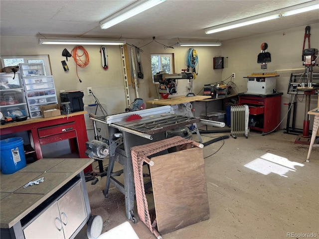 garage featuring radiator heating unit and a workshop area