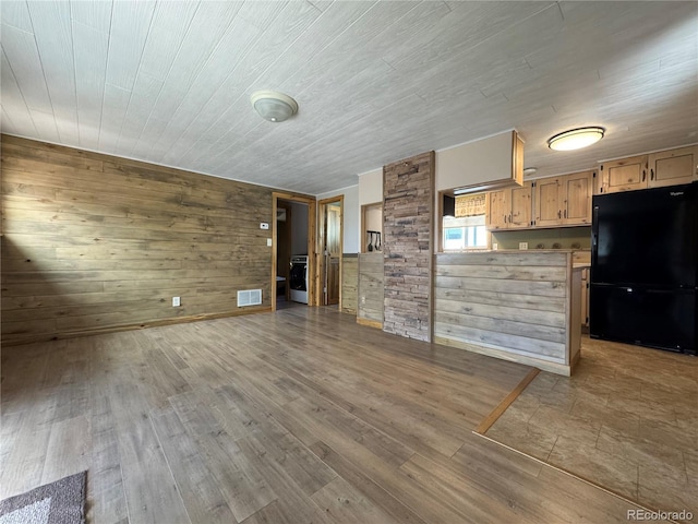 163 Holiday Hills Blvd, Howard, CO 81233 - unfurnished living room featuring wood walls and wood finished floors