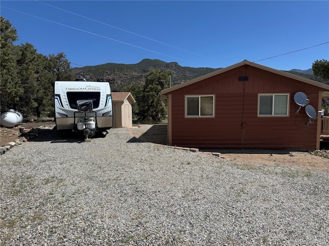 163 Holiday Hills Blvd, Howard, CO 81233 - view of side of home with a mountain view, a shed, and an outbuilding