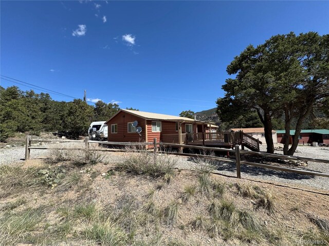 163 Holiday Hills Blvd, Howard, CO 81233 - rustic home with a wooden deck, faux log siding, and fence