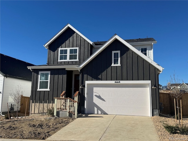 modern farmhouse style home featuring driveway, board and batten siding, and fence