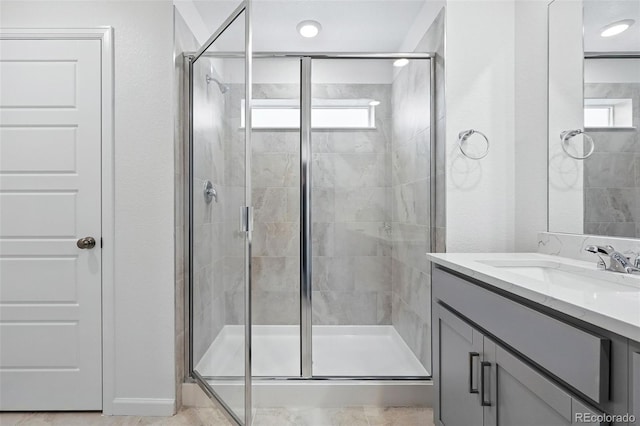 bathroom with a stall shower and a healthy amount of sunlight