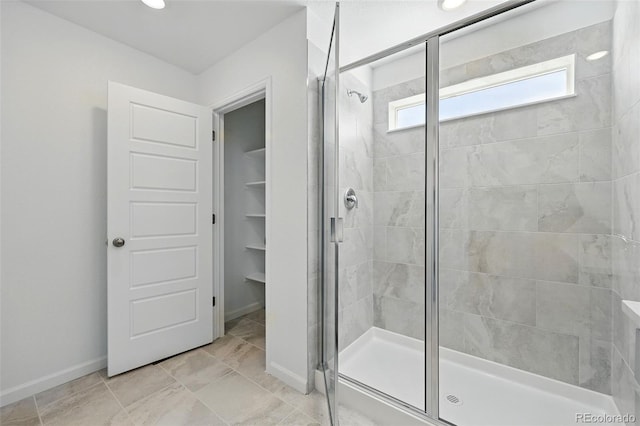 bathroom featuring recessed lighting, baseboards, and a stall shower