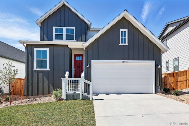 modern farmhouse with board and batten siding, driveway, a garage, and fence