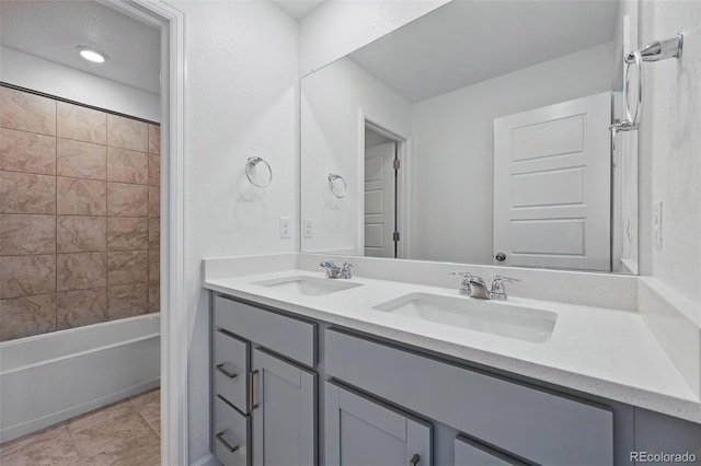 full bathroom featuring a sink, double vanity, and shower / bathing tub combination