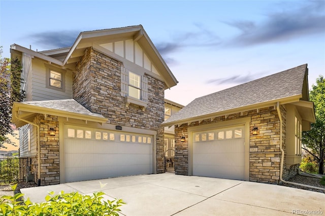 27565 E Nova Pl, Aurora, CO 80016 - view of front of house with stone siding, a shingled roof, driveway, and a garage