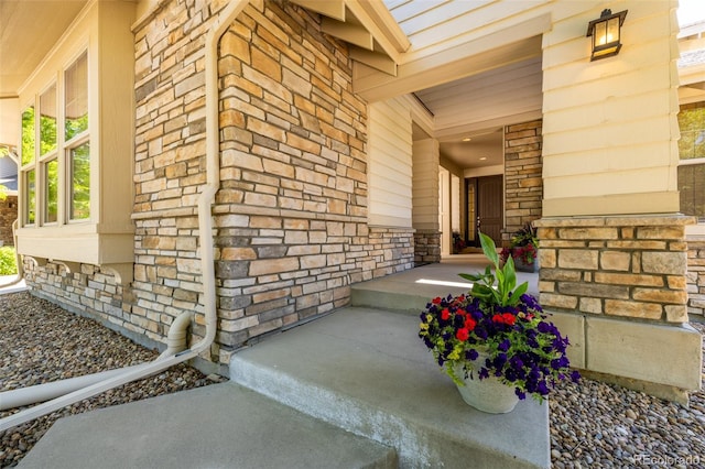 27565 E Nova Pl, Aurora, CO 80016 - doorway to property featuring covered porch, stone siding, and brick siding
