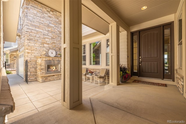 27565 E Nova Pl, Aurora, CO 80016 - property entrance with stone siding, an outdoor stone fireplace, and covered porch