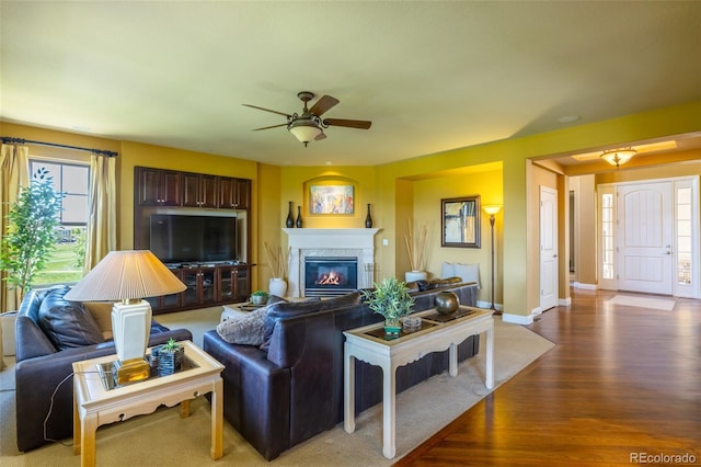 27565 E Nova Pl, Aurora, CO 80016 - living area featuring light wood-style floors, ceiling fan, and a glass covered fireplace