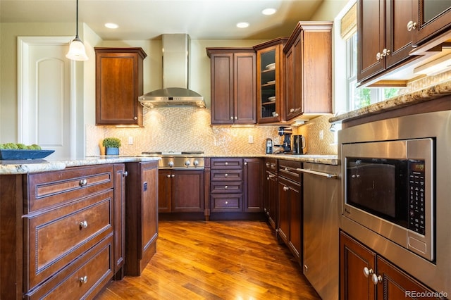 27565 E Nova Pl, Aurora, CO 80016 - kitchen with stainless steel appliances, wall chimney range hood, dark wood-style floors, light stone counters, and tasteful backsplash