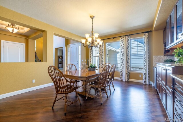 27565 E Nova Pl, Aurora, CO 80016 - dining space featuring a chandelier and dark wood-style flooring