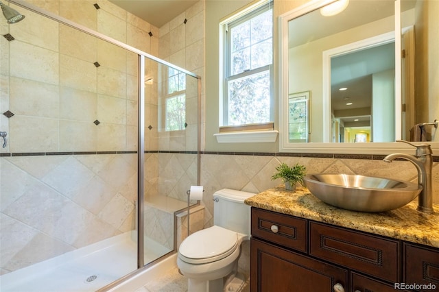 27565 E Nova Pl, Aurora, CO 80016 - full bath with vanity, a shower stall, and tile walls