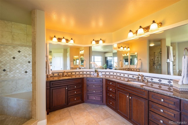 27565 E Nova Pl, Aurora, CO 80016 - bathroom with double vanity, a tile shower, and tile patterned floors