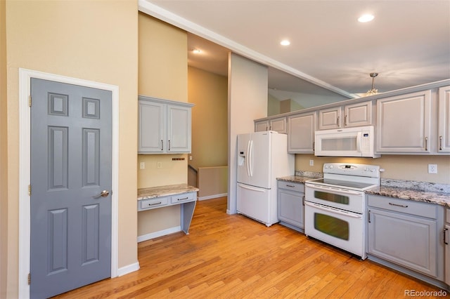 kitchen with white appliances, gray cabinetry, light wood finished floors, recessed lighting, and baseboards