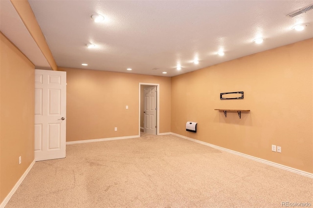 below grade area with light colored carpet, baseboards, and recessed lighting