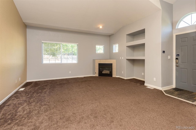 9025 W 79th Way Unit D, Arvada, CO 80005 - unfurnished living room featuring built in features, healthy amount of natural light, and dark carpet
