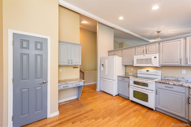 9025 W 79th Way Unit D, Arvada, CO 80005 - kitchen with white appliances, gray cabinets, light wood-style flooring, recessed lighting, and light stone countertops