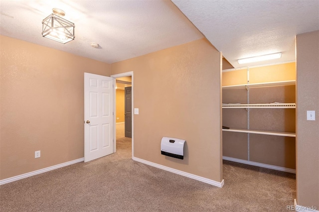 9025 W 79th Way Unit D, Arvada, CO 80005 - unfurnished bedroom featuring carpet flooring, a closet, a textured ceiling, and heating unit