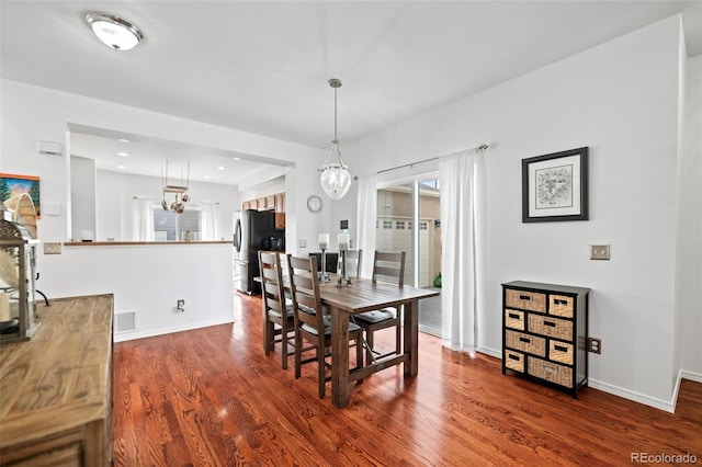 dining space with hardwood / wood-style flooring