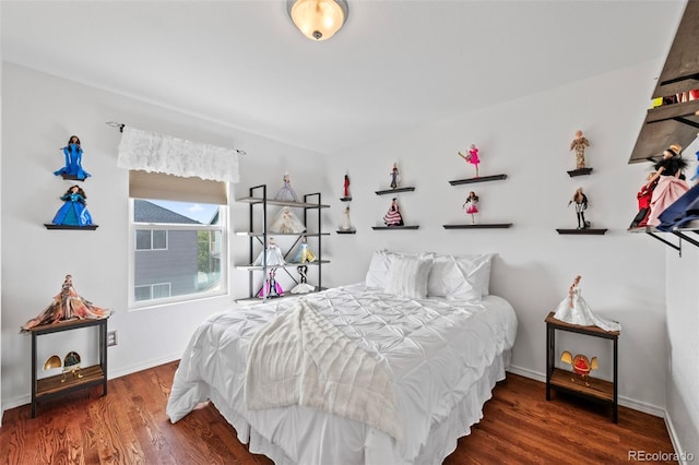 bedroom with dark hardwood / wood-style flooring