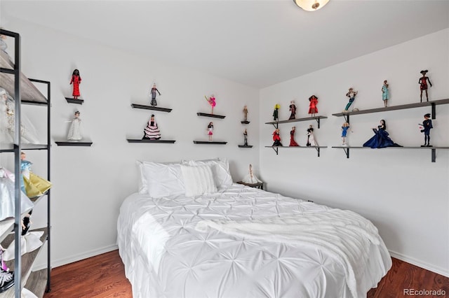 bedroom with dark wood-type flooring