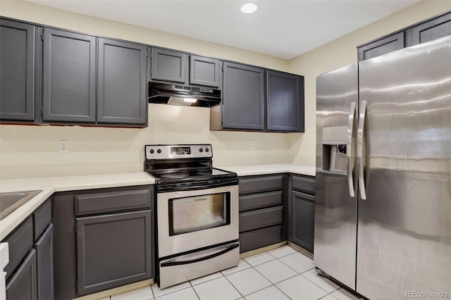 7474 E Arkansas Ave Unit 18-10, Denver, CO 80231 - kitchen featuring stainless steel appliances, under cabinet range hood, light tile patterned flooring, light countertops, and recessed lighting