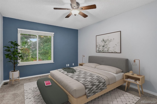 7474 E Arkansas Ave Unit 18-10, Denver, CO 80231 - bedroom featuring a textured ceiling, carpet, and a ceiling fan
