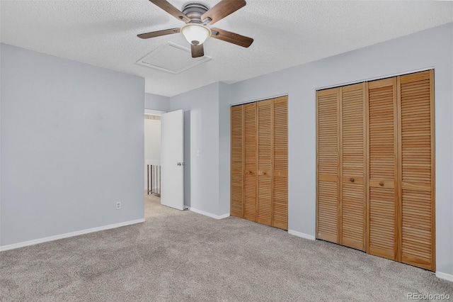 7474 E Arkansas Ave Unit 18-10, Denver, CO 80231 - unfurnished bedroom featuring multiple closets, carpet, a textured ceiling, and ceiling fan