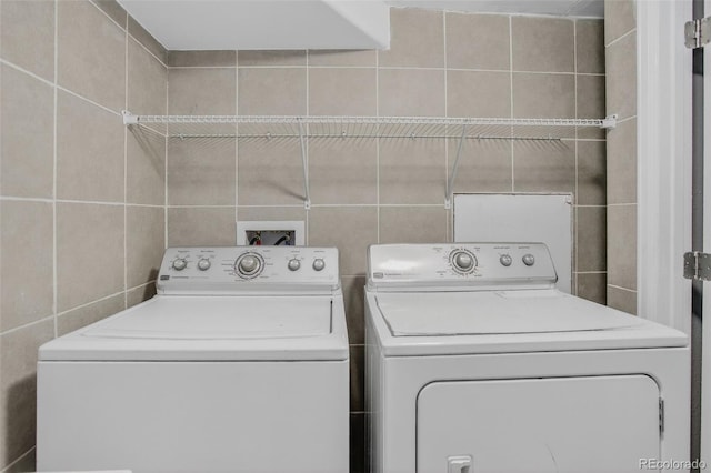 7474 E Arkansas Ave Unit 18-10, Denver, CO 80231 - washroom with tile walls and washing machine and dryer