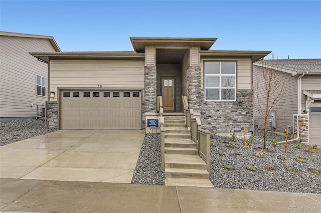 231 Leafy Aster Ln, Castle Rock, CO 80104 - prairie-style house with stone siding, an attached garage, and driveway