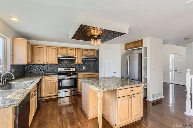 kitchen with sink, a kitchen island, dark hardwood / wood-style flooring, and stainless steel appliances