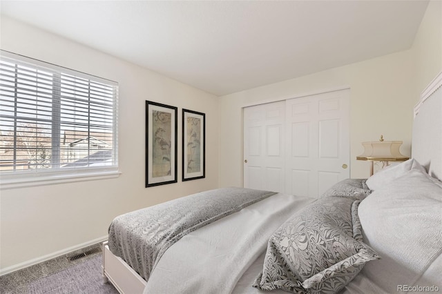 bedroom with light carpet and a closet