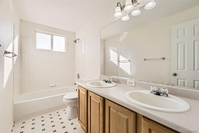 full bathroom with vanity, tiled shower / bath combo, and toilet