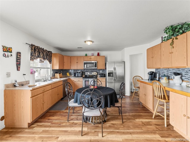 4906 Perth St, Denver, CO 80249 - kitchen featuring appliances with stainless steel finishes, decorative backsplash, light wood-type flooring, and light countertops