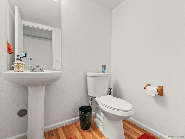 4906 Perth St, Denver, CO 80249 - half bathroom featuring wood finished floors