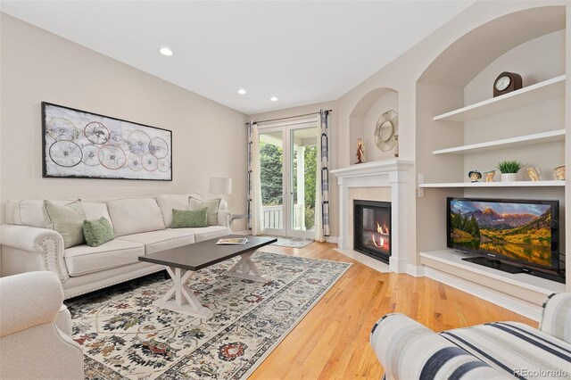 6520 S Newcastle Way, Aurora, CO 80016 - living room featuring wood finished floors, recessed lighting, and a fireplace
