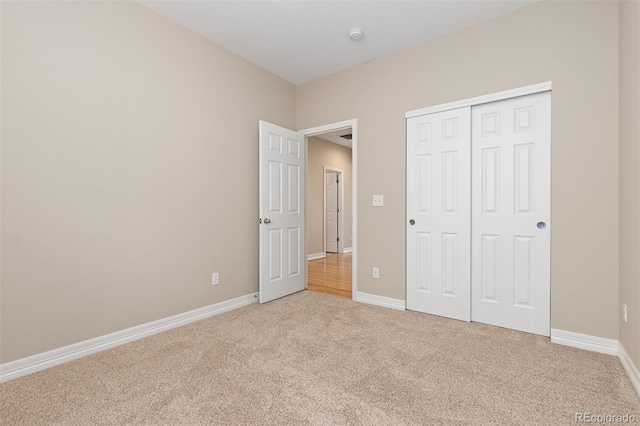 6520 S Newcastle Way, Aurora, CO 80016 - unfurnished bedroom with light carpet, a closet, and baseboards