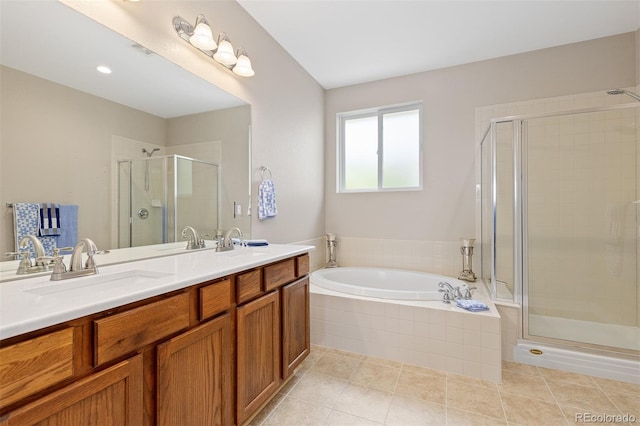 6520 S Newcastle Way, Aurora, CO 80016 - full bathroom featuring a stall shower, double vanity, a garden tub, and tile patterned flooring