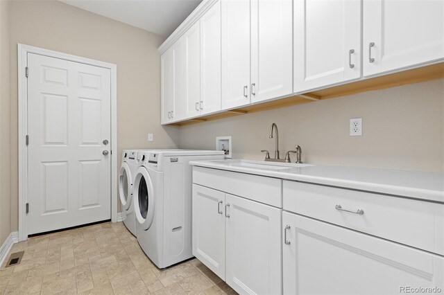 6520 S Newcastle Way, Aurora, CO 80016 - laundry room featuring cabinet space, separate washer and dryer, and baseboards
