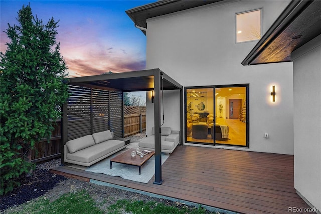 wooden terrace with an outdoor living space and fence