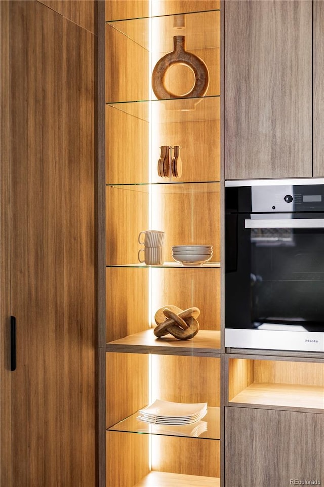 interior details featuring modern cabinets, oven, and brown cabinets