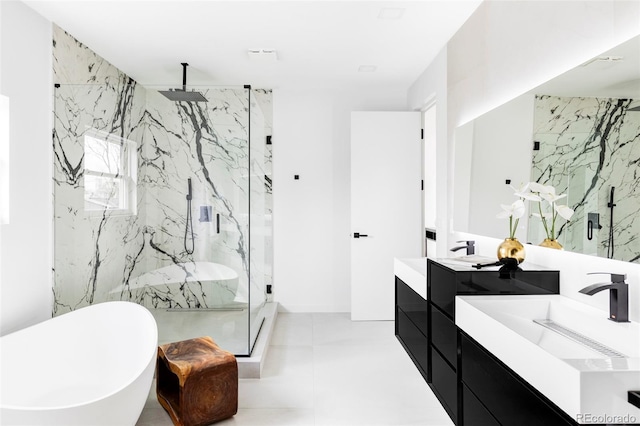 bathroom featuring a marble finish shower, a soaking tub, and vanity