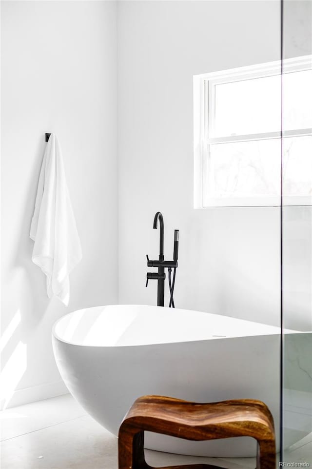 full bath featuring a soaking tub