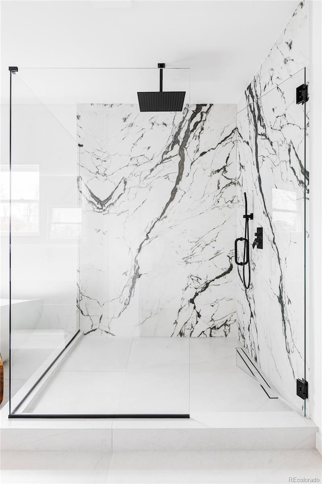 full bathroom with a marble finish shower