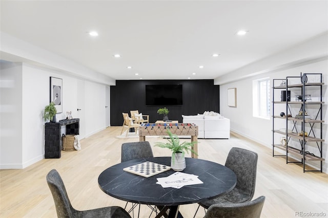 dining area featuring light wood finished floors, baseboards, and recessed lighting