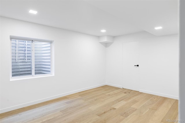 unfurnished room with baseboards, recessed lighting, and light wood-style floors
