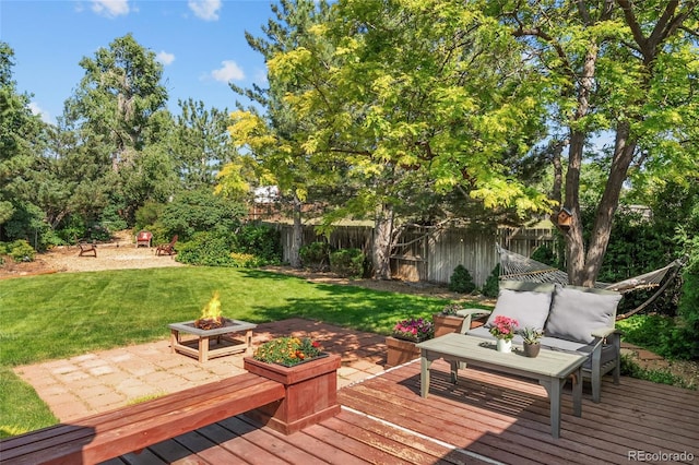 16563 E Kansas Pl, Aurora, CO 80017 - wooden deck with a fenced backyard and an outdoor living space with a fire pit