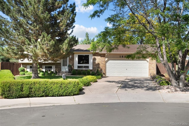 16563 E Kansas Pl, Aurora, CO 80017 - view of front of house with an attached garage, brick siding, and concrete driveway
