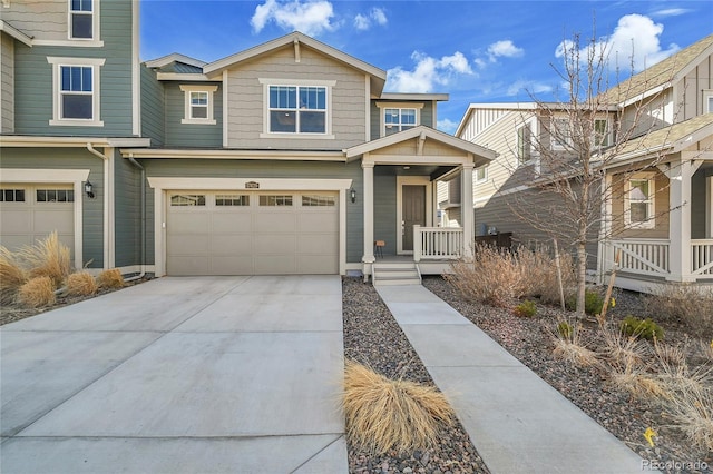 view of front of house featuring a porch, driveway, and a garage